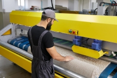 Man operating carpet automatic washing machine in professional cleaning service